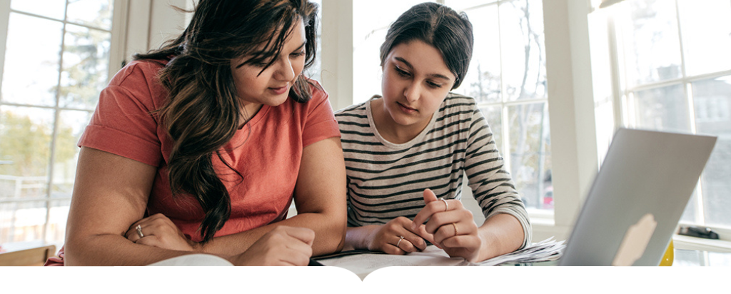 Mother helping daughter with homework