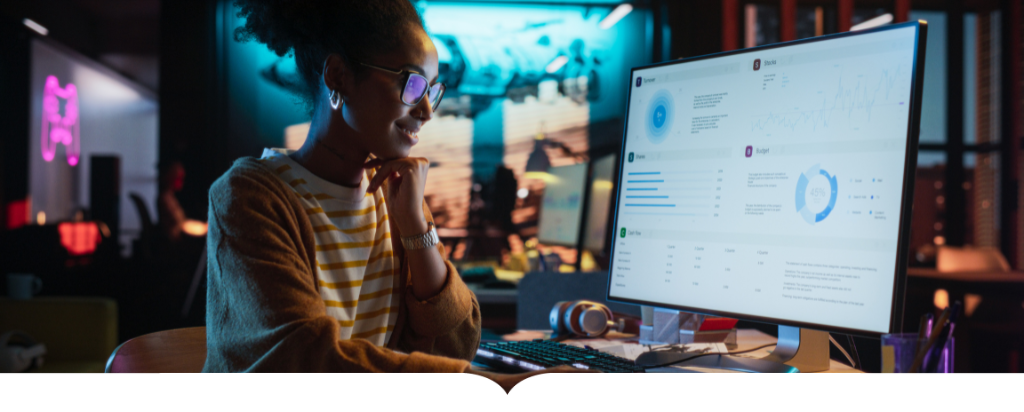 Woman at her computer smiling while looking her screen