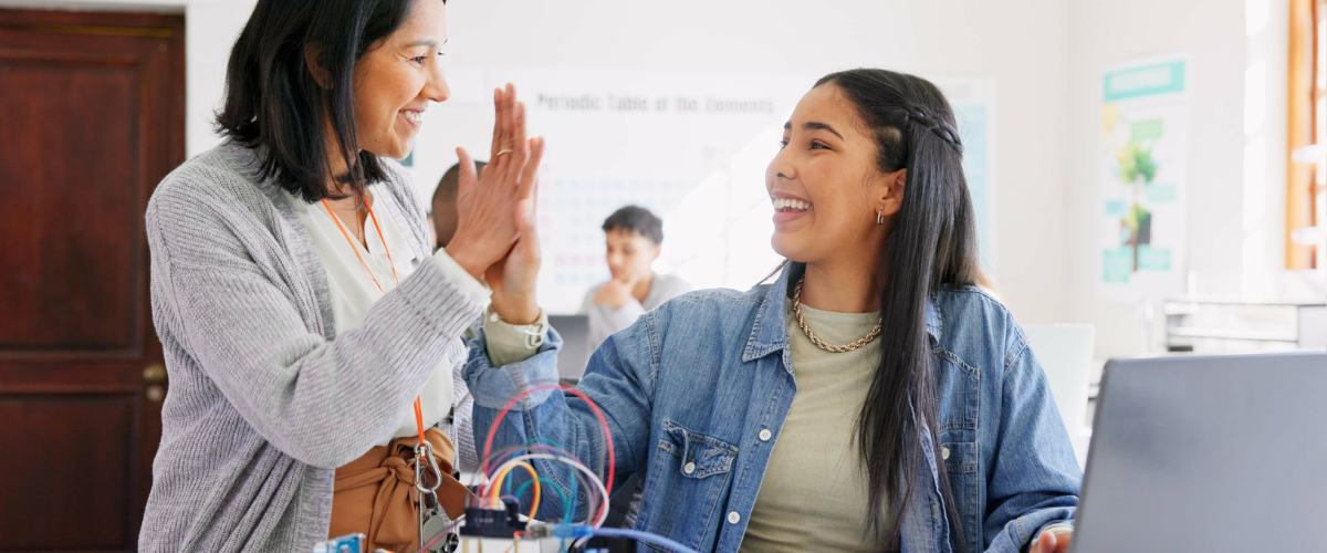 Student high fiving a teacher