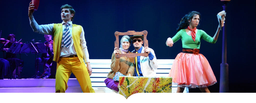 Four students on stage during a theater production